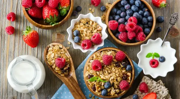 Pyszne śniadanie: granola z owocami, jogurt i mleko. Idealne dla diety bogatoresztkowej.